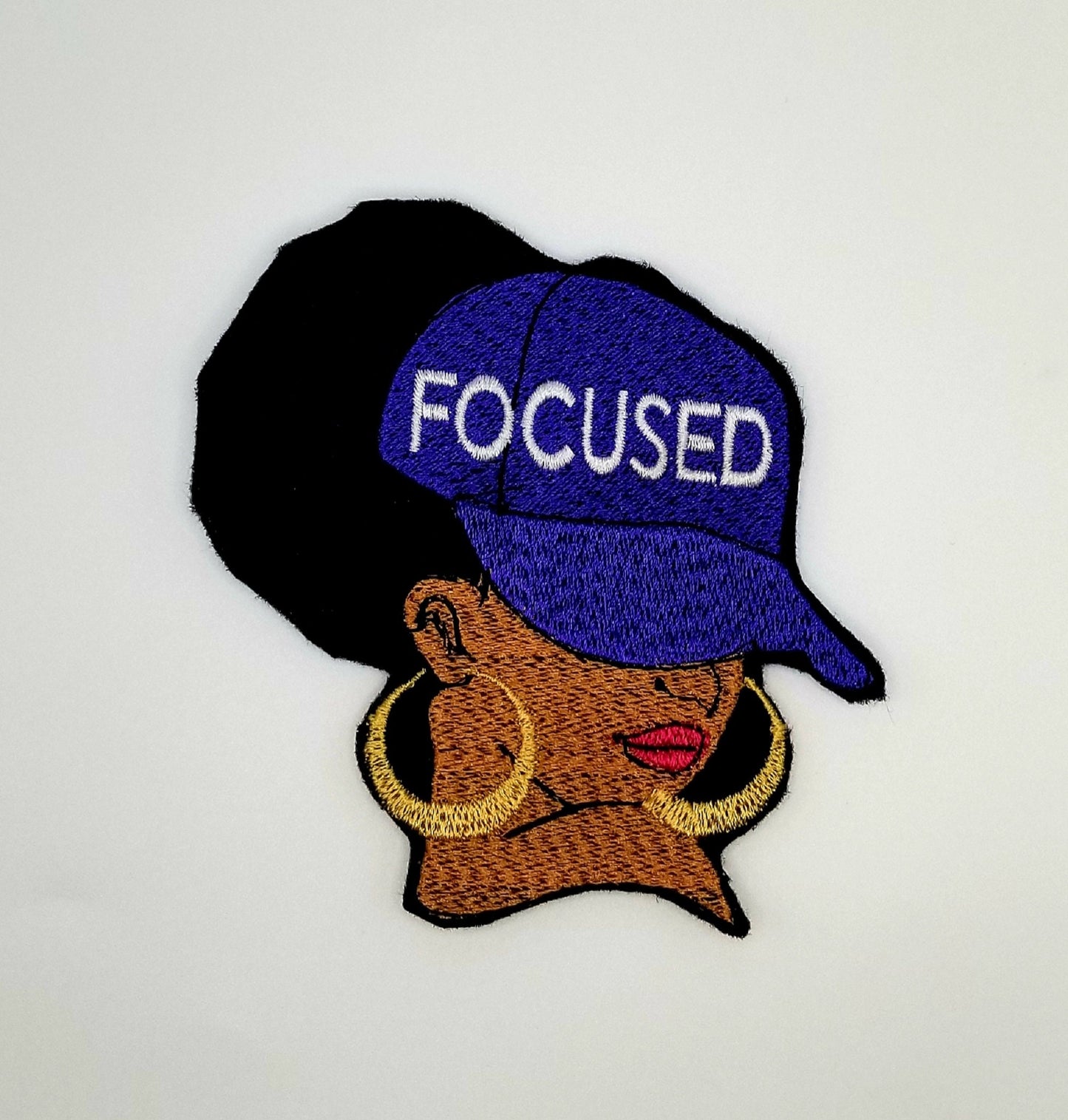 Afro Woman "FOCUSED" Sew on Patch wit Iron on backing . 3d Black woman Patch, Ball Cap with FOCUSED on the Cap wearing Earrings....9.97