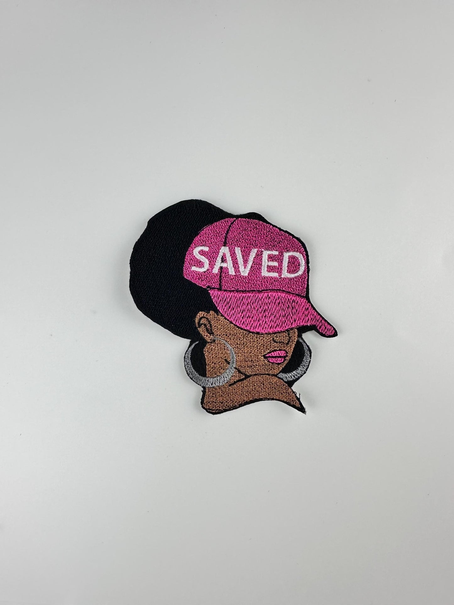 Afro Woman "SAVED" Sew on Patch with Iron on backing, wearing a Ball Cap with saved on the Cap and wearing Earrings...."9.97