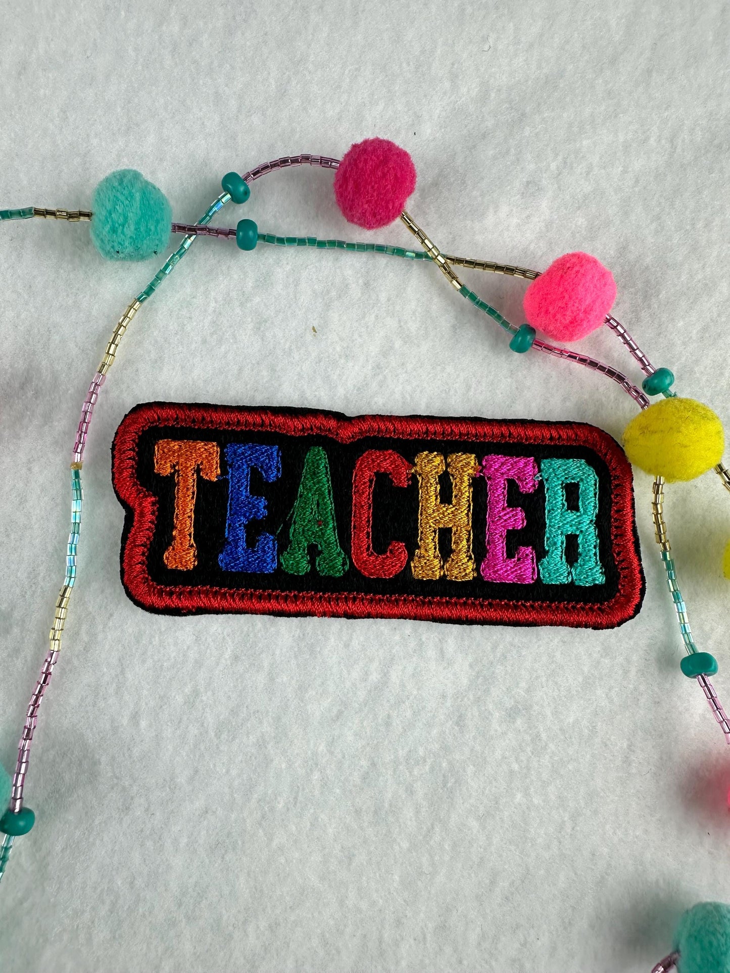 TEACHER Embroidery Patch – Whimsical Colorful Letters with Red Satin Border 6.53